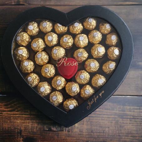 Een hart vol Ferrero Rocher met in het midden een klein ringdoosje in de vorm van een roos